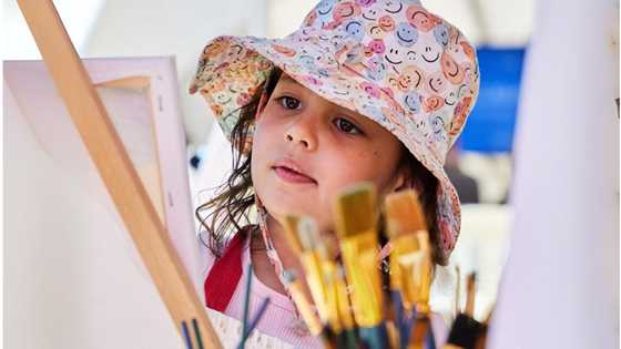 Young child painting at Scribblers family festival