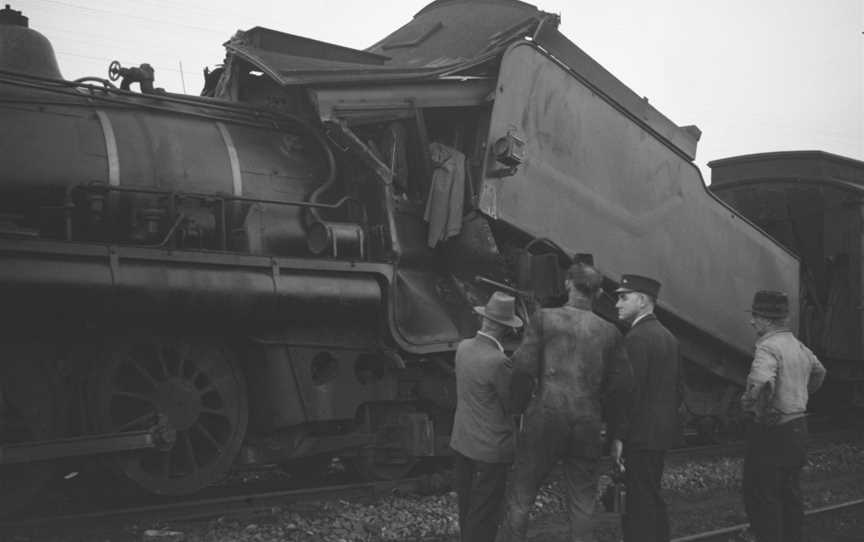 Railwayworkerslookingatthedamagedtraintenderafteracrashat Tamaree COctober1947