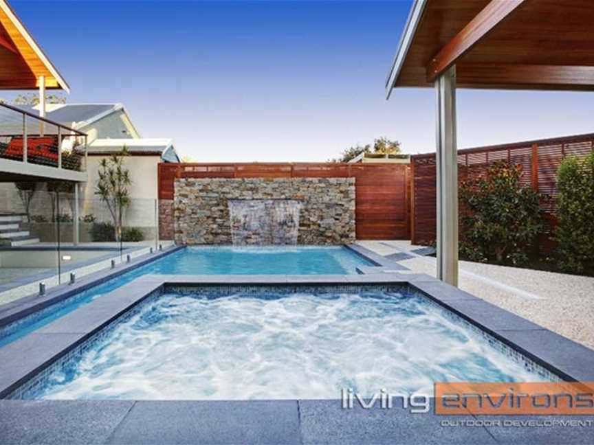 Custom concrete pool and spa with water feature wall. Designed and built by Living Environs.