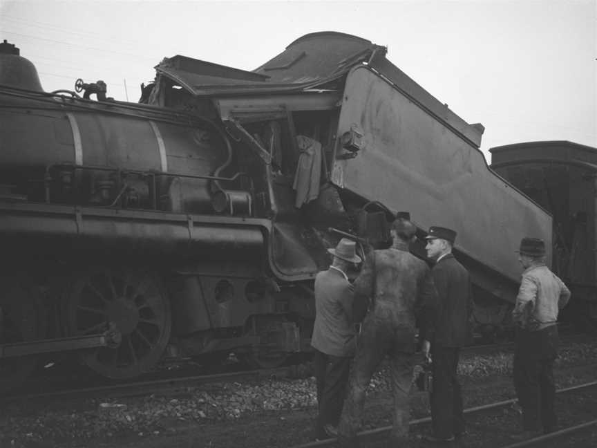 Railwayworkerslookingatthedamagedtraintenderafteracrashat Tamaree COctober1947