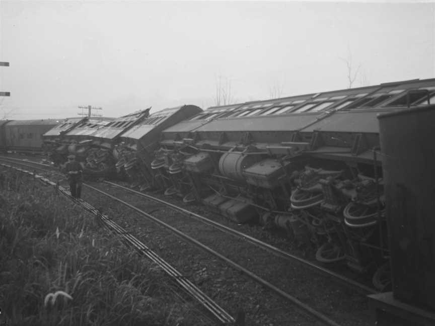 Railwayengineandcarriagesontheirsidesonthetrackafterbeinginvolvedinacollisionat Tamaree COctober1947