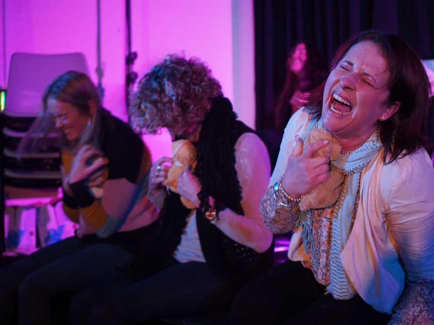 Hypnotised on stage volunteers laughing