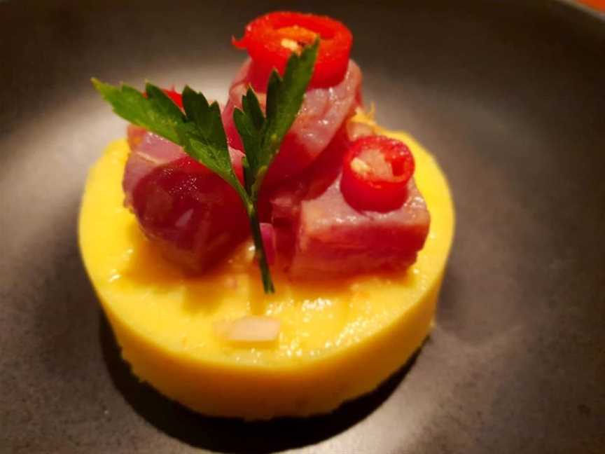 Causa: Peruvian-Japanese fusion of lime infused spicy mashed potato with aji amarillo and topped with soy-marinated tuna ceviche.