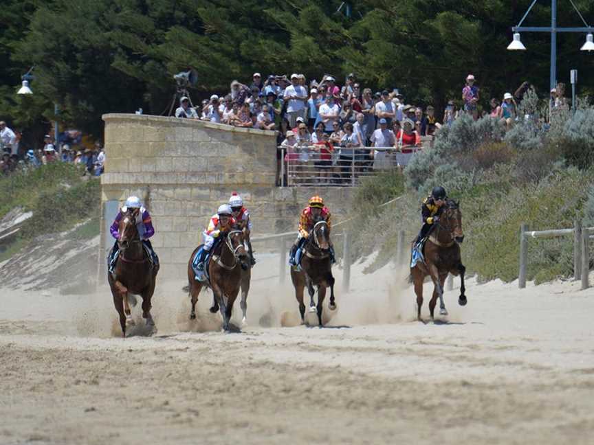 Horses racing on beach