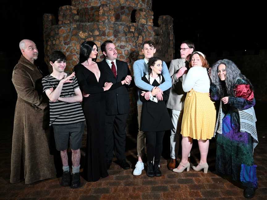 When worlds collide… the Addams family meet Wednesday’s boyfriend Lucas (Matthew Walford, centre) and his parents Mal (Alan Gill, third from right) and Alice (Elizabeth Elliott, second from right).