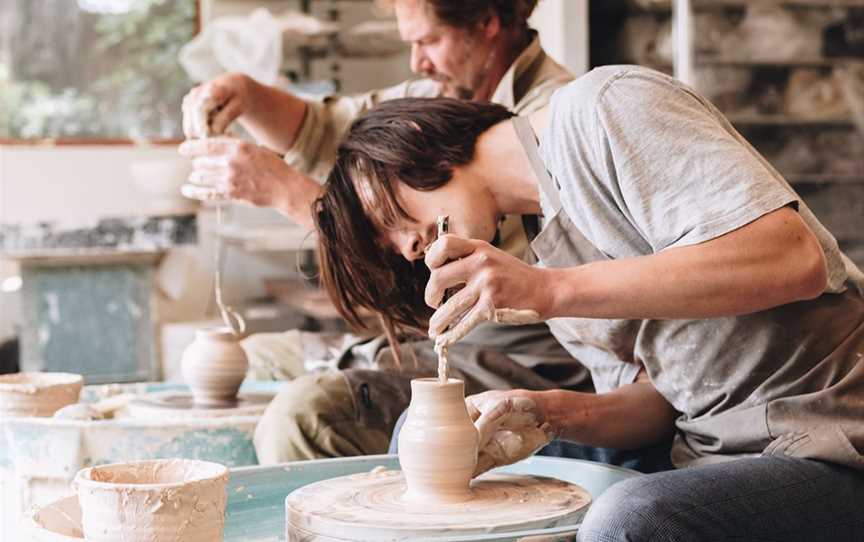 Father and son, Myles and Finn Happ make small bud vases.